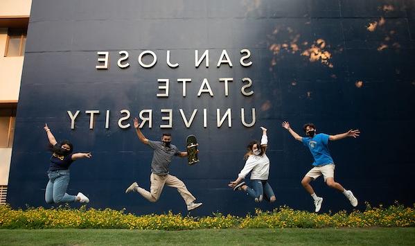 菠菜网lol正规平台 students jumping in joy in front of a 'San Jose State University' sign